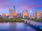Downtown Austin skyline after sunset, purple sky with a full moon