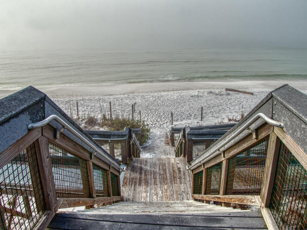 Grayton Beach, Florida with wooden steps leading down to the beach and sea beyond.