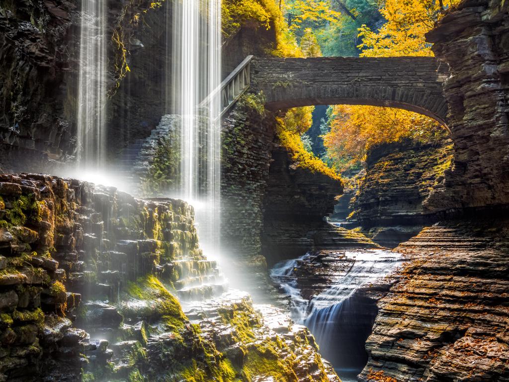 Watkins Glen State Park waterfall canyon in Upstate New York with stone bridges in the distance.