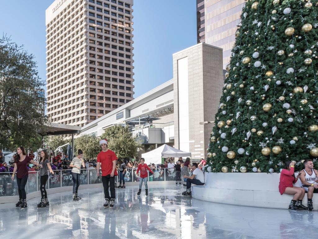 People Ice Skating in downtown Phoenix at Christmas time with a Christmas Tree