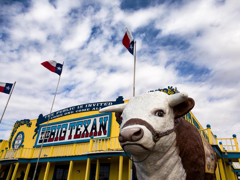 The Big Texan Restaurant with the iconic cow sculpture in the foreground
