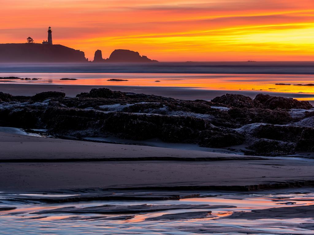 Beautiful colorful sunset over the ocean and Yaquina Head Lighthouse