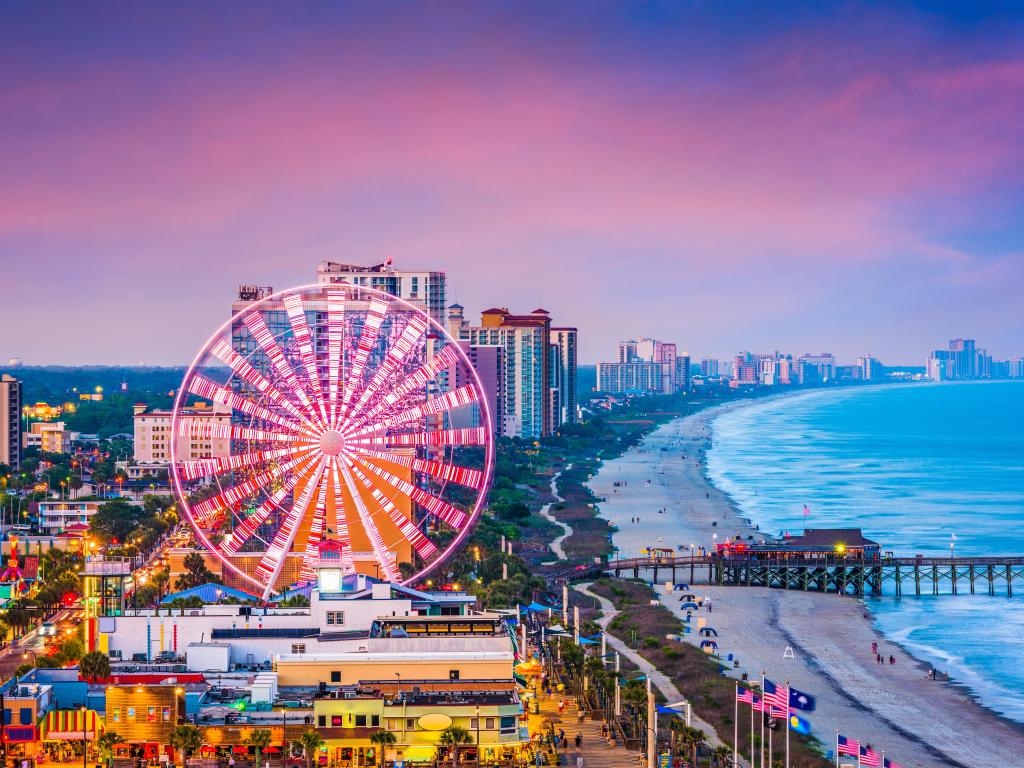 Myrtle Beach in South Carolina at dusk with the city skyline and beach.