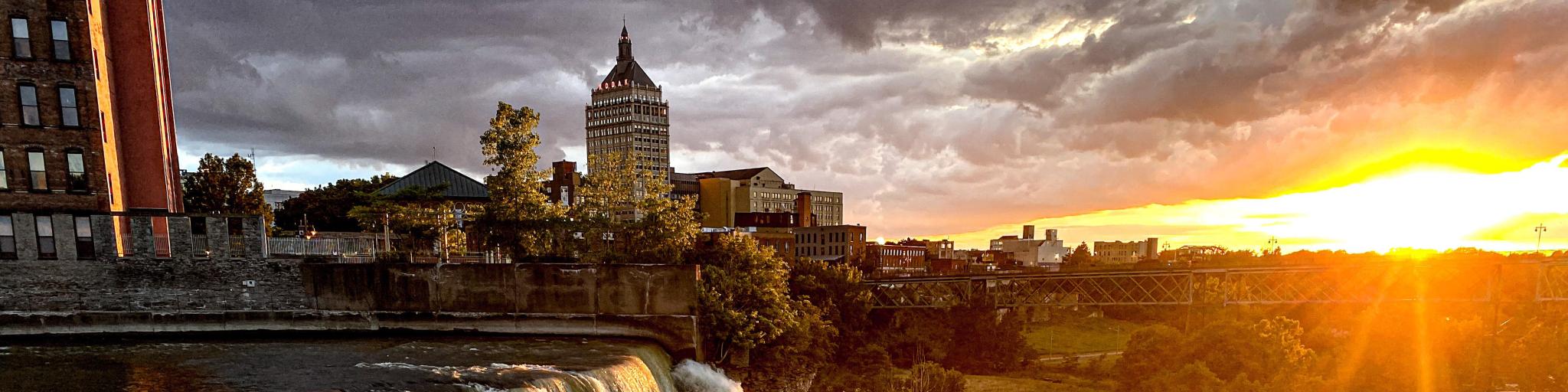 Rochester skyline during sunset with the famous waterfalls in the foreground