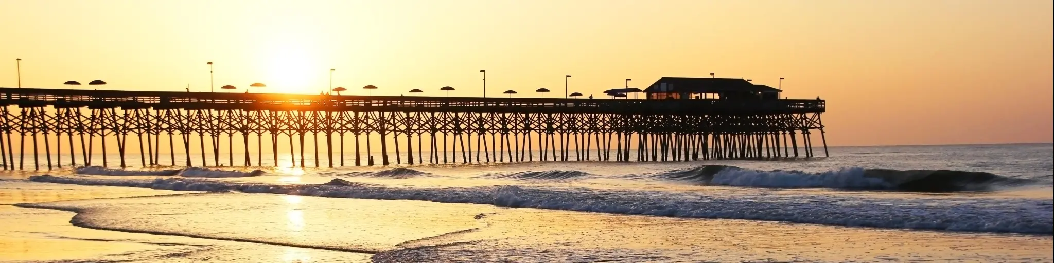 Sunrise over the Ocean. Atlantic Ocean view with a pier in Myrtle Beach, South Carolina, USA.