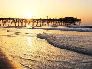 Sunrise over the Ocean. Atlantic Ocean view with a pier in Myrtle Beach, South Carolina, USA.