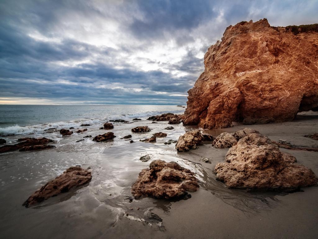 Malibu, California, USA with a view of the scenic rocks at sunset time at El Matador Ocean Beach in Malibu.