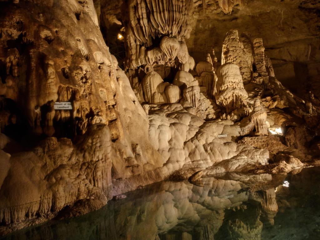 Natural Bridge Caverns in San Antonio, Texas, USA with a view of the rock formations underground with water reflecting the rocks in the foreground.