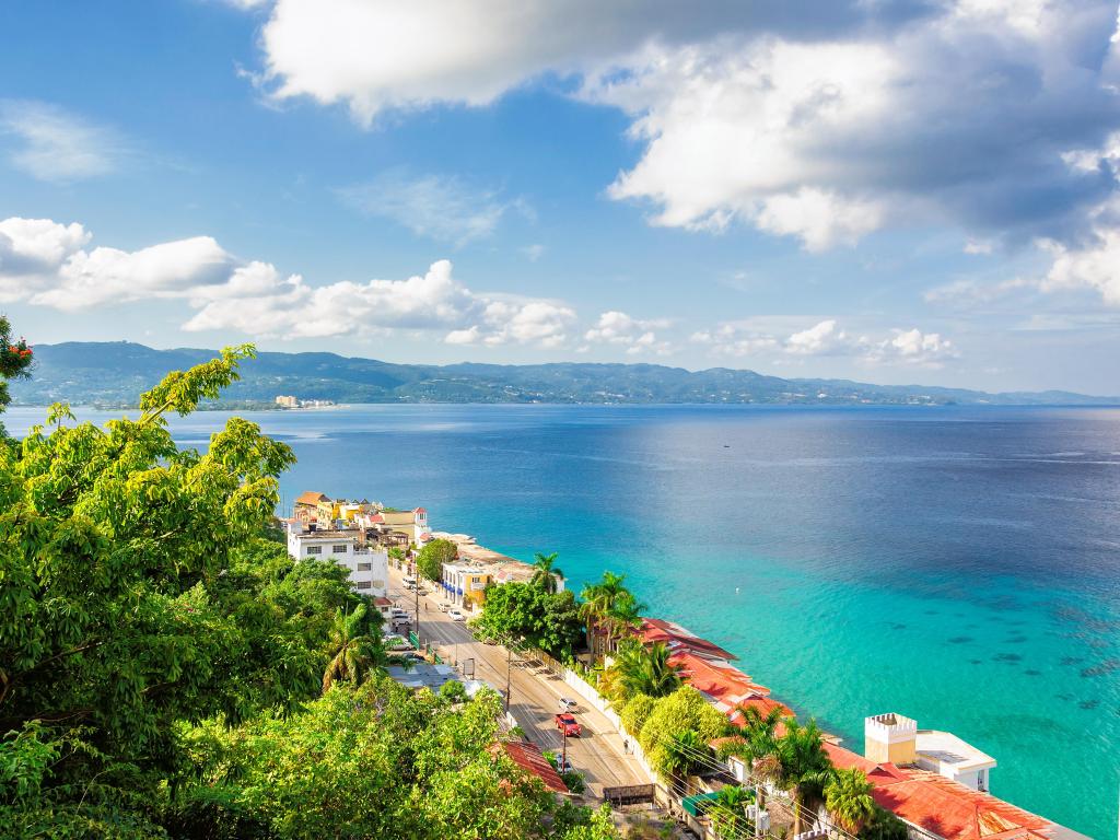 View from a hill onto Montego Bay on a sunny day with some clouds in the sky