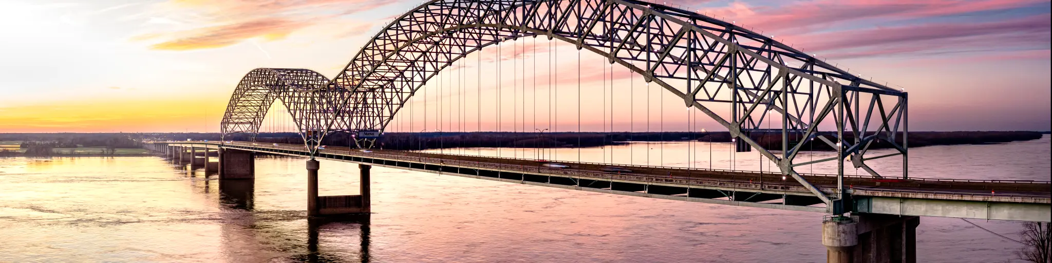 Hernando de Soto Bridge connecting Memphis, Tennessee with West Memphis, Arkansas at sunset.