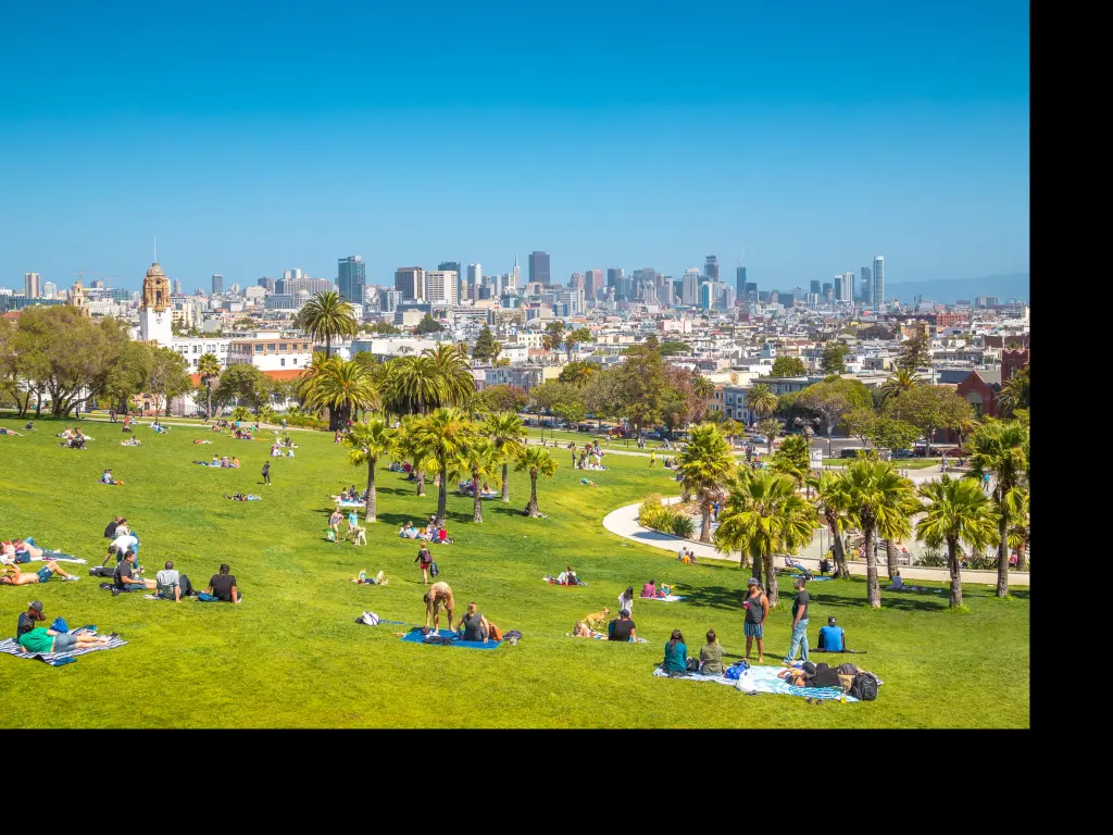 View of San Francisco from Mission Dolores Park with people relaxing