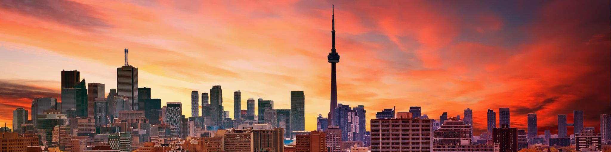 Sunset over Toronto Skyline with red and orange hues and the CN Tower in the center