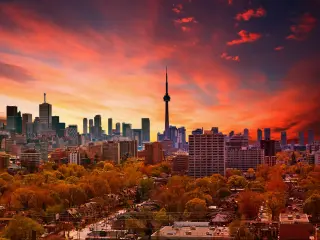 Sunset over Toronto Skyline with red and orange hues and the CN Tower in the center