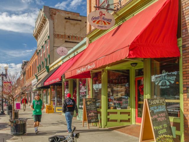 Downtown Ogden with shops and eateries lining the road with pedestrians on the sidewalk