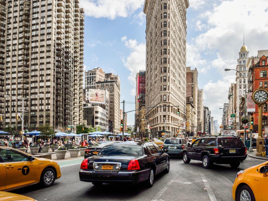 Exterior of the Flatiron Building, New York, with cars