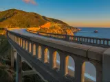 A view from the road running over the Bixby Creek Bridge on the Pacific Coast Highway in California near Big Sur at sunset 