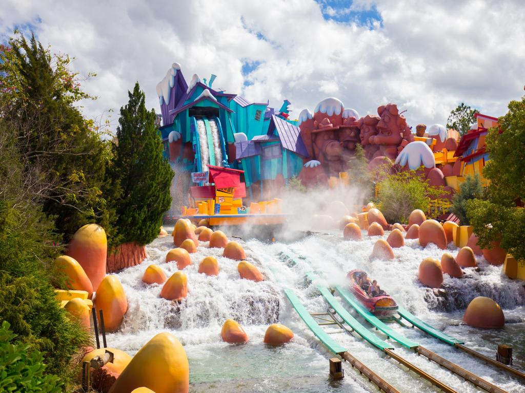 People riding the Toon Lagoon ride in Islands of Adventure Theme Park.