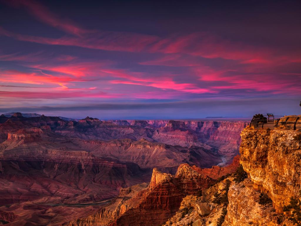 Vibrant pink sunset over deep rocky canyon at Grand Canyon National Park
