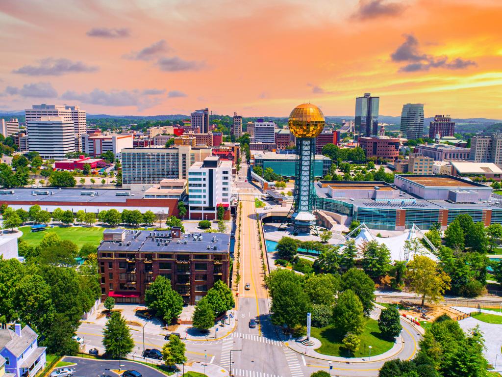 Knoxville, Tennessee, TN Downtown Drone Skyline Aerial. Photo is taken during a sunset with some clouds in the sky.