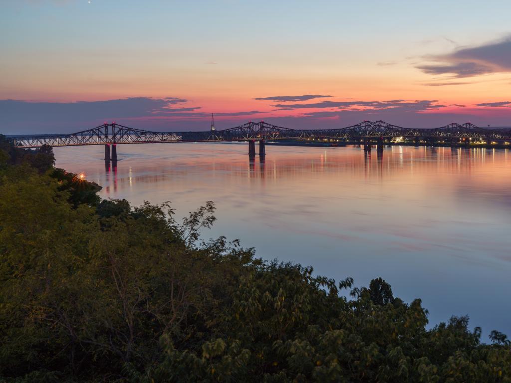 Natchez-Vidalia bridge across the Mississippi River at sunset in Natchez, Mississippi.