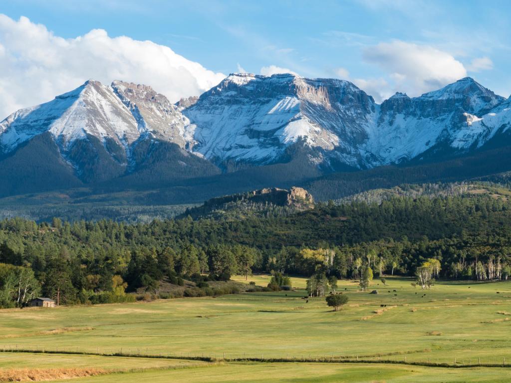 Rocky Mountains, Colorado, USA with a view of the cattle ranch below the Dallas divide mountains in Southwest Colorado on a clear sunny day.