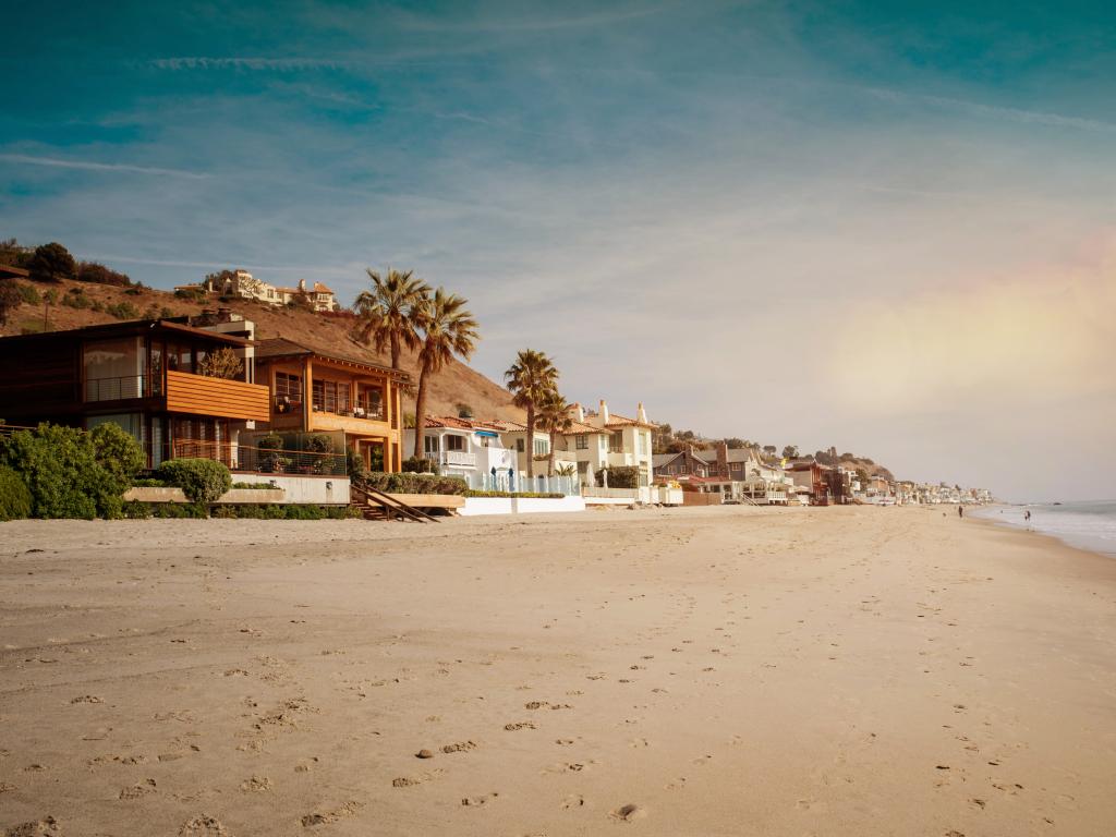 White sand of a beach in Malibu at sunset.