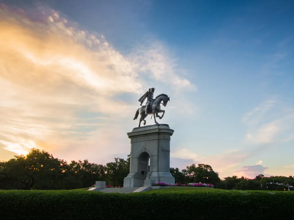 Sam Houston Statue, positioned on a concrete archway in the park, photo taken during sunset