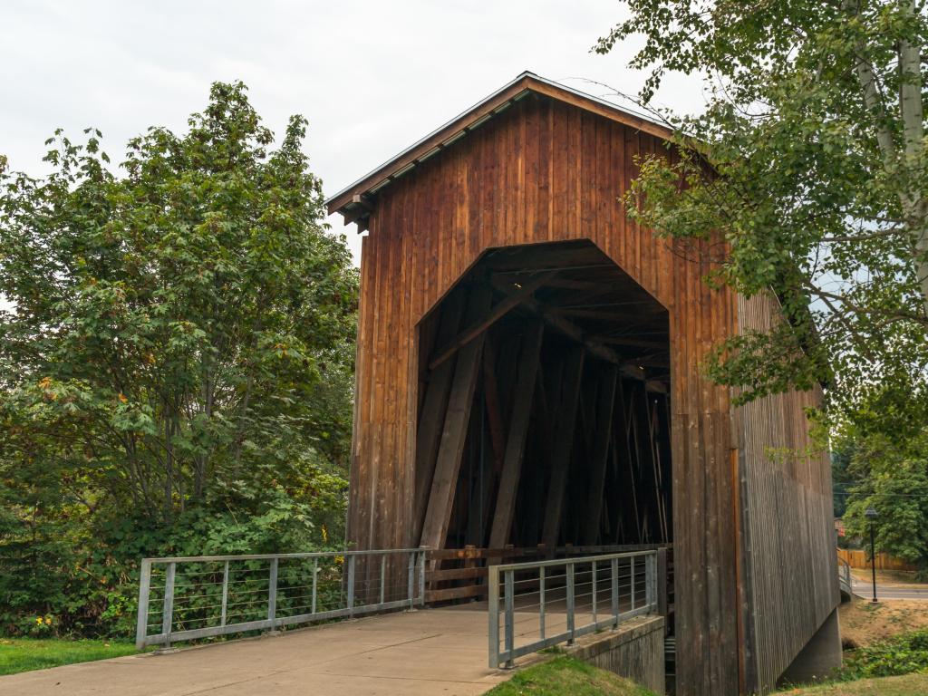 Historic covered railroad bridge on an overcast day