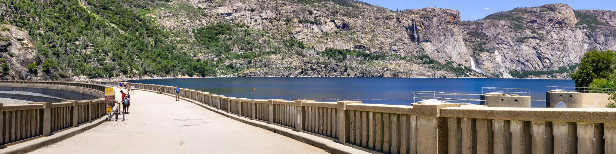Paved road on top of O'Shaughnessy Dam and Hetch Hetchy Reservoir visible on the right