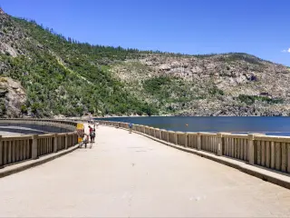 Paved road on top of O'Shaughnessy Dam and Hetch Hetchy Reservoir visible on the right