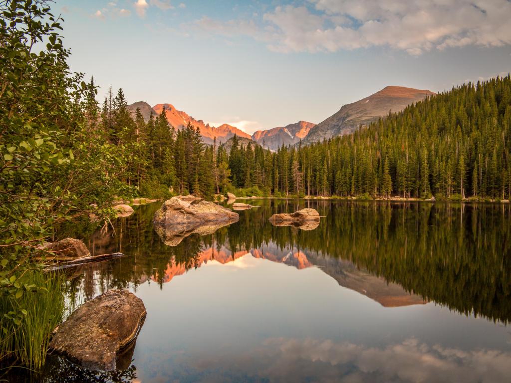 Sunset reflection of mountains and rocks at Bear Lake in Rocky Mountain National Park, Colorado.
