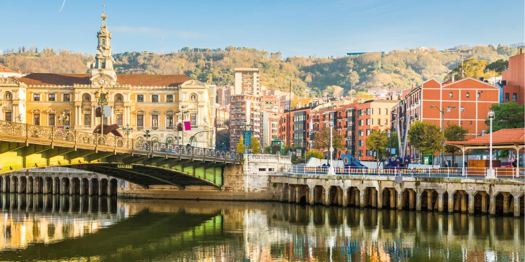 Reflection of the buildings on the river in Bilbao, Spain, on a sunny day