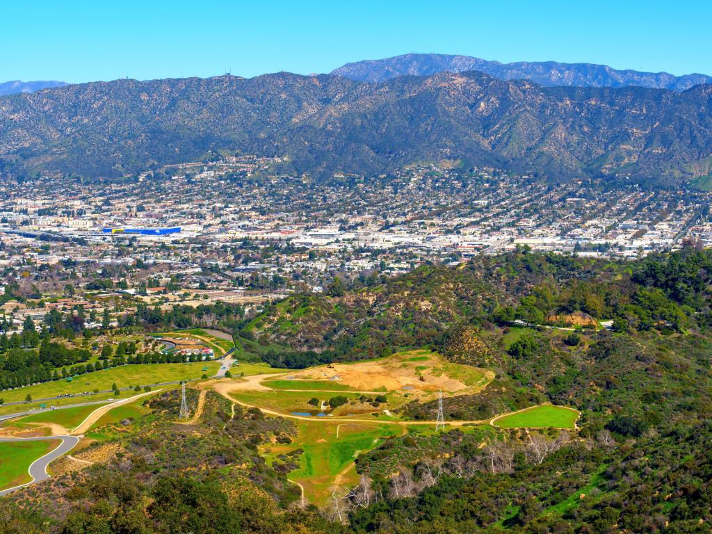 Panoramic view of the Hollywood Hills and the sprawling city of Los Angeles as seen from the vantage point near the iconic Hollywood Sign.