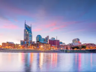 Nashville, Tennessee, USA with the downtown skyline with Cumberland River in USA at sunset.