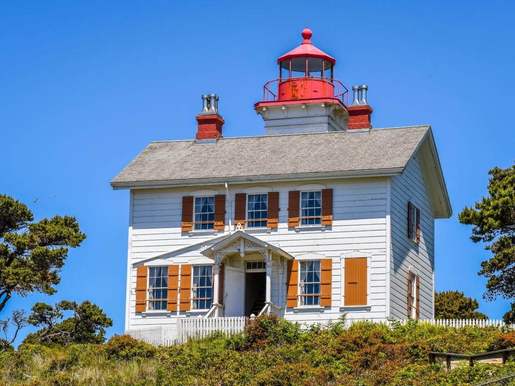 Charming small lighthouse without a tower, on a sunny day