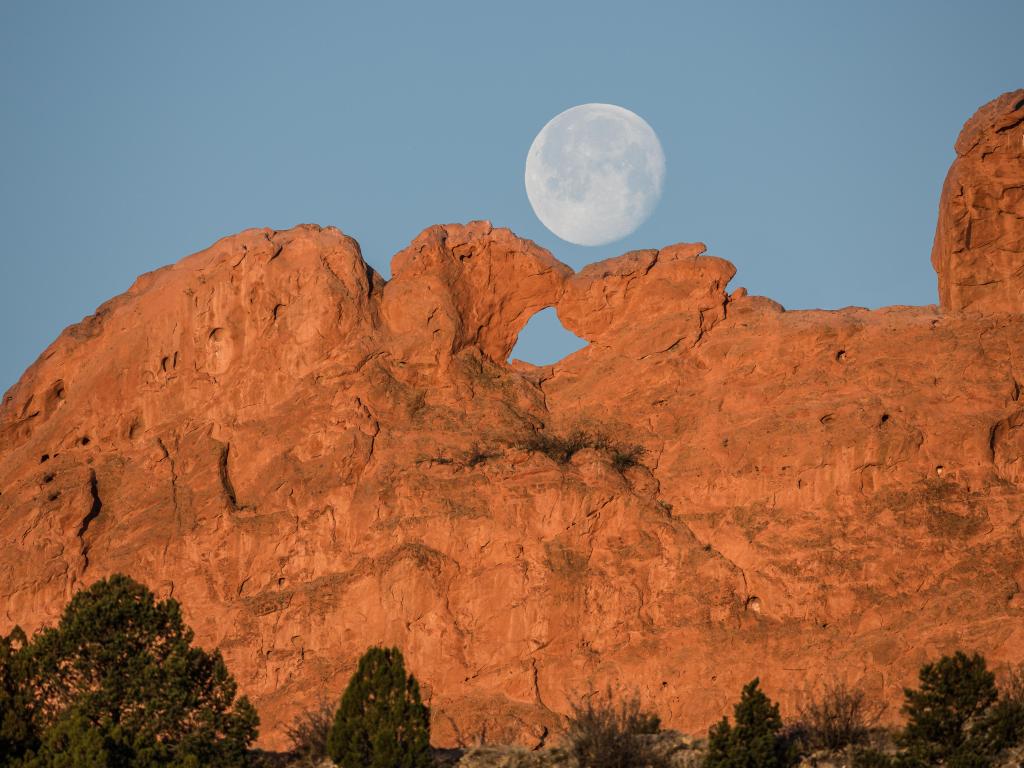 Full moon setting over Kissing Camels in the Garden of the Gods
