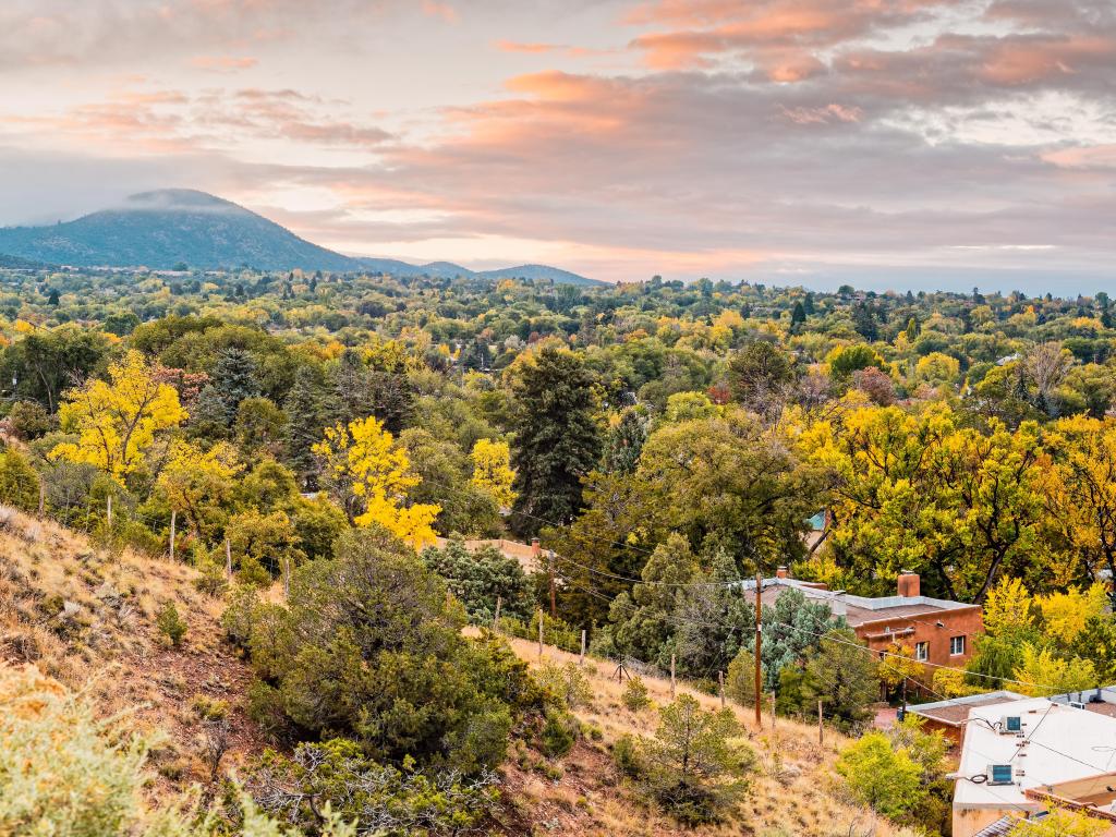 Santa Fe, New Mexico, USA taken during fall at sunrise with a panorama of Santa Fe and mountains in the distance. 