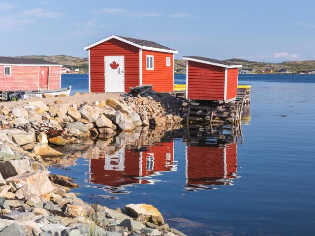 The fishing village of Tilting, Fogo Island,with two red cabins on the water