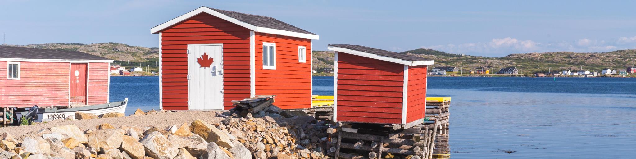 The fishing village of Tilting, Fogo Island,with two red cabins on the water