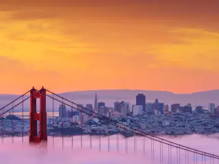 Early morning low fog at Golden Gate Bridge with the skyline in the background