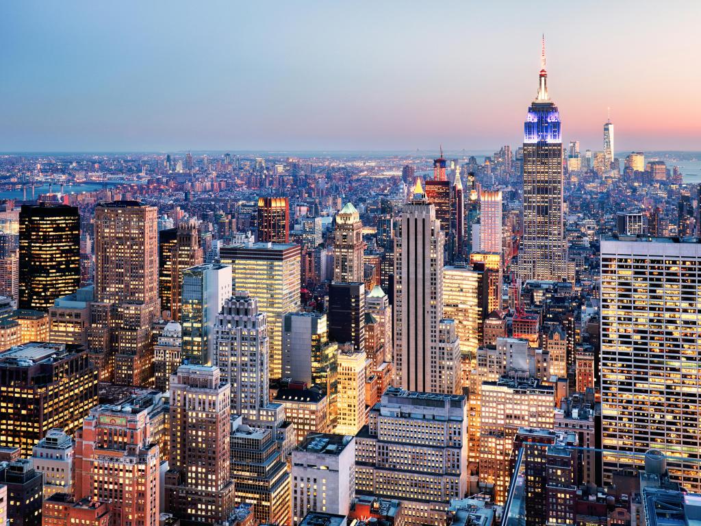 New York City, USA with a view of the city skyline at sunset.