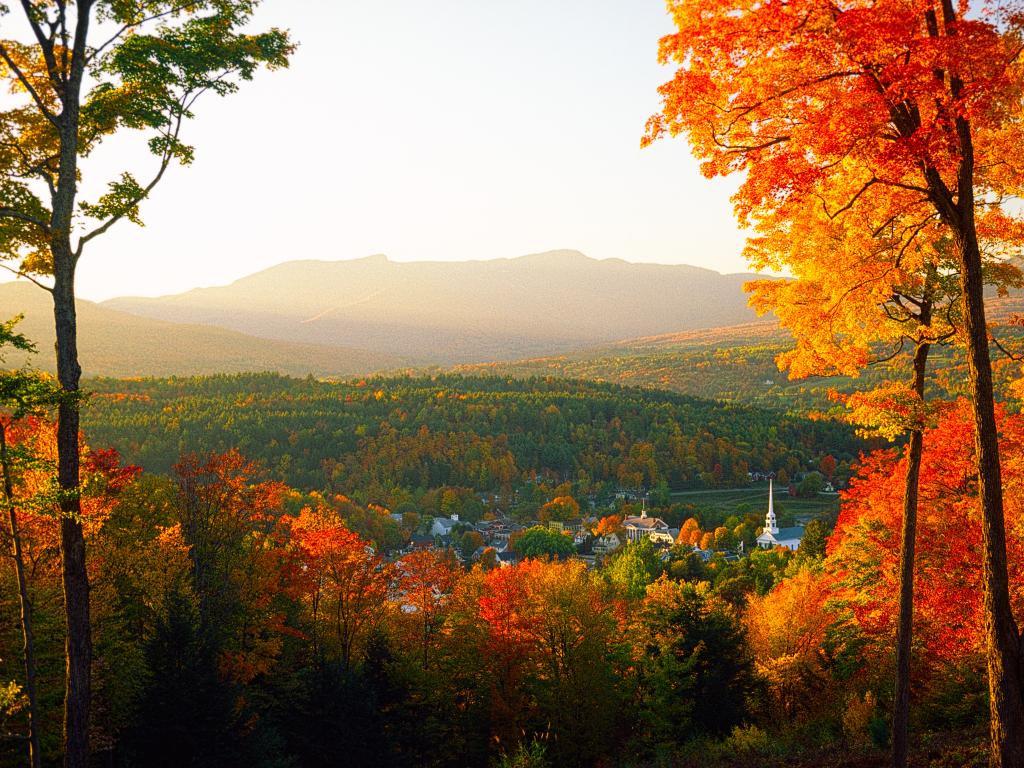 View down to the town of Stowe, Vermont with the Stowe Community Church in the fall.