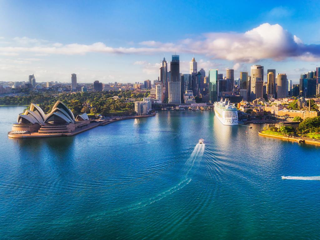 Sydney Harbour, Australia with the famous landmarks of the city in the background, boats in the sea in the foreground in the sunshine. 