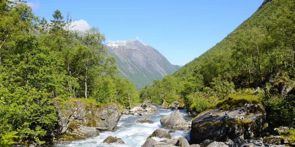 A bubbling river runs through a valley in Norway's Trollstigen region