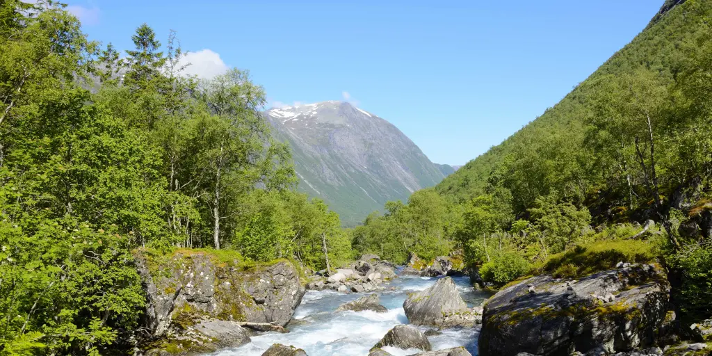 A bubbling river runs through a valley in Norway's Trollstigen region