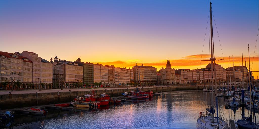 Sailboats float in the La Coruna marina at sunset