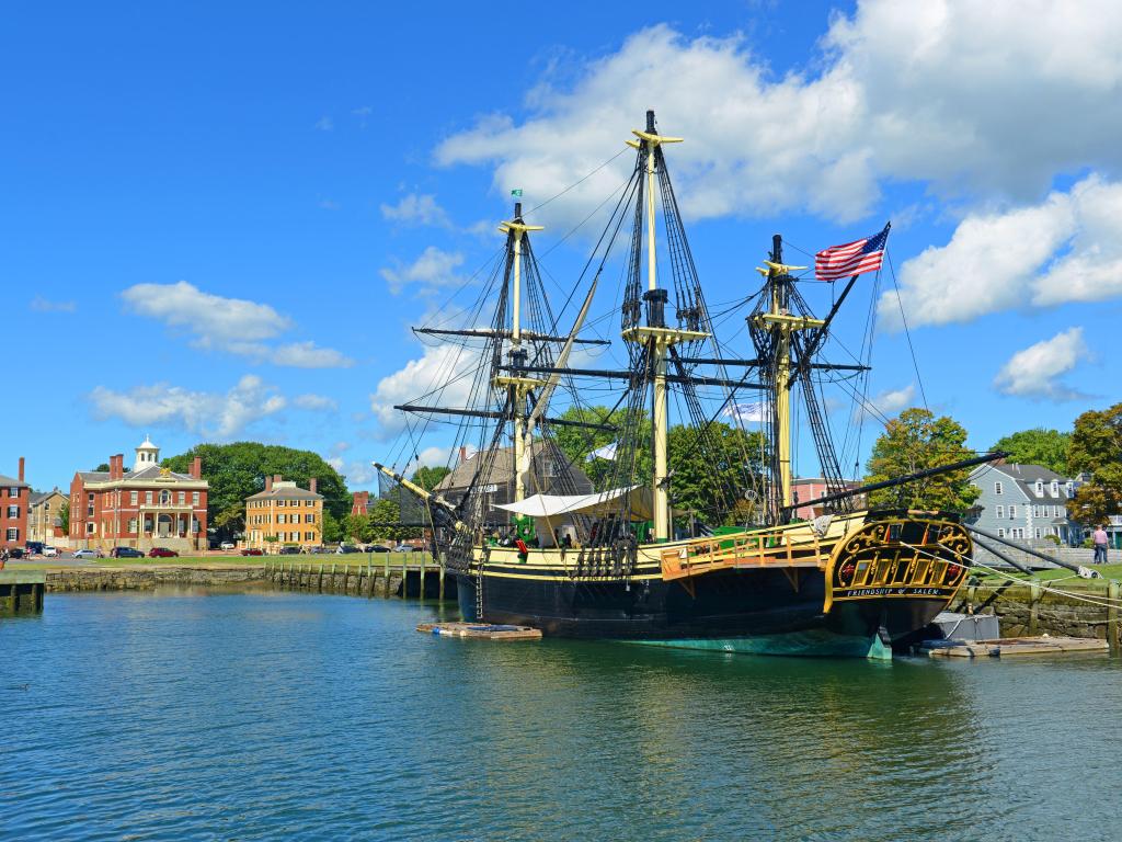 Historic wooden ship Friendship of Salem at the Salem Maritime National Historic Site on a partially cloudy day