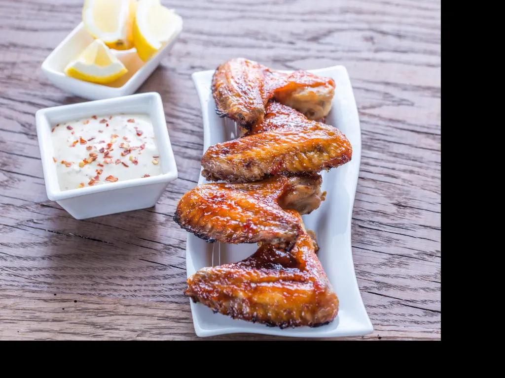 BBQ chicken wings served with Alabama white sauce