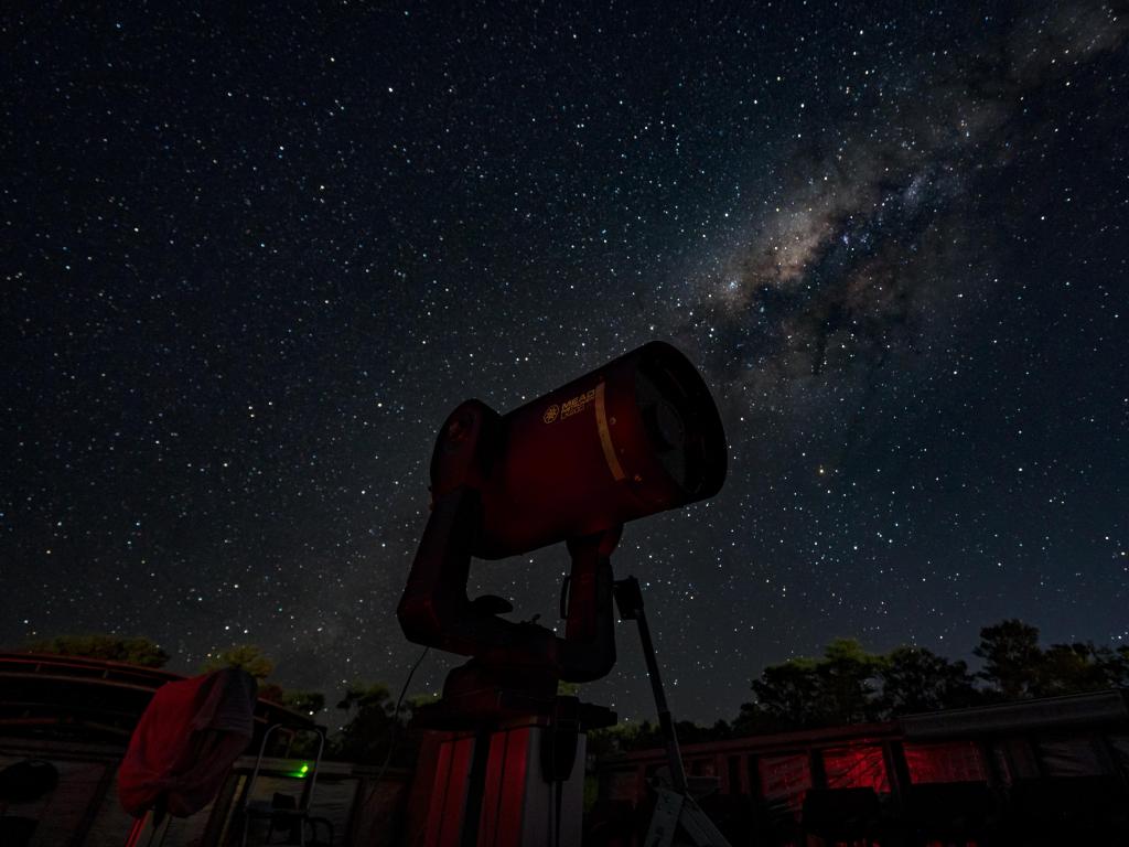 Cosmos Centre observatory telescope at night with milky way in the background