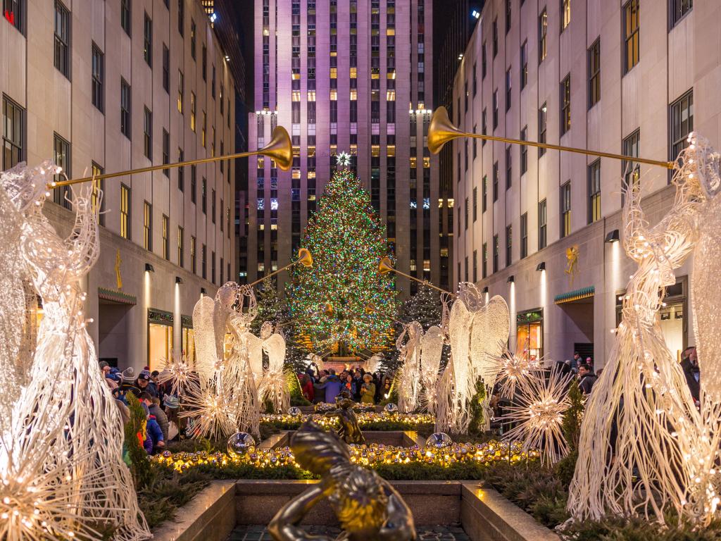 Rockefeller Center decorated for the holidays, with festive lights at night time